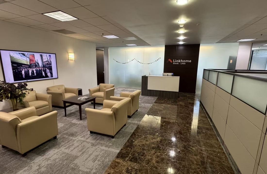 Linkhome reception area, with the company mark and the LHAI ticker on the wall